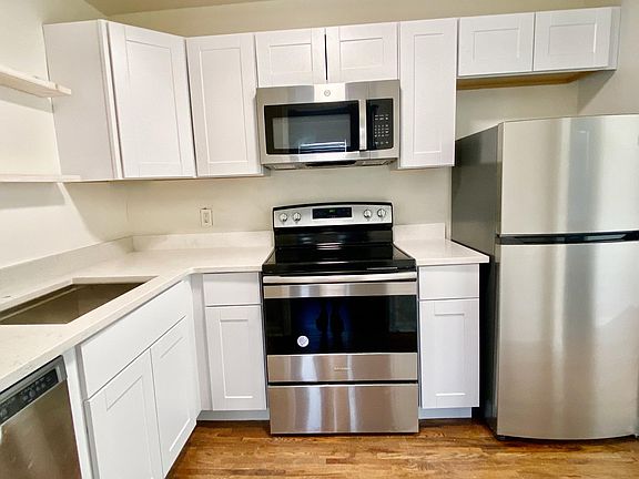 Newly updated kitchen with granite countertops and stainless steel appliances.
