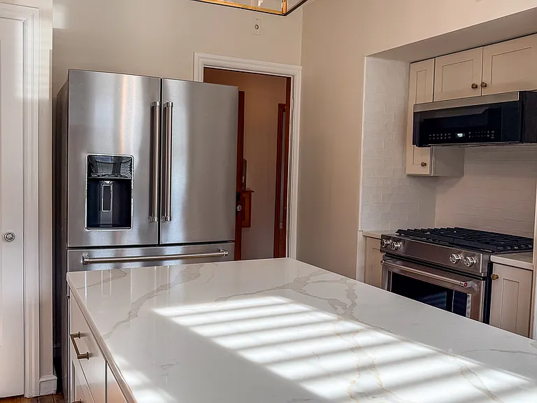 Kitchen Aid refrigerator with French Doors and beverage drawer.