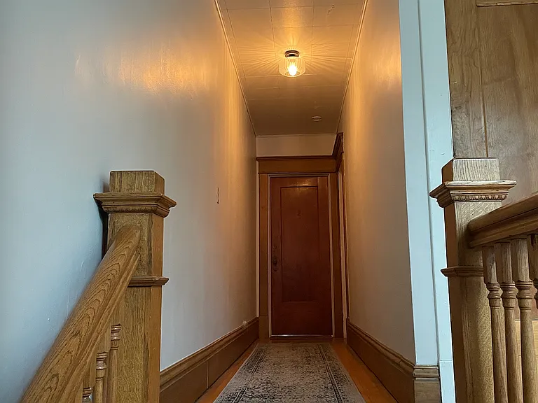 Hallway leading to apartment doorway.