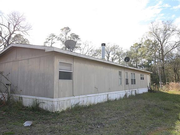 YEAR 2002 PER MONTGOMERY APPRAISAL DISTRICT, DOUBLE WIDE, REAR VIEW