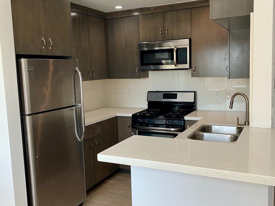 Upgraded kitchen with quartz stone counters, custom cabinets and stainless steel appliances