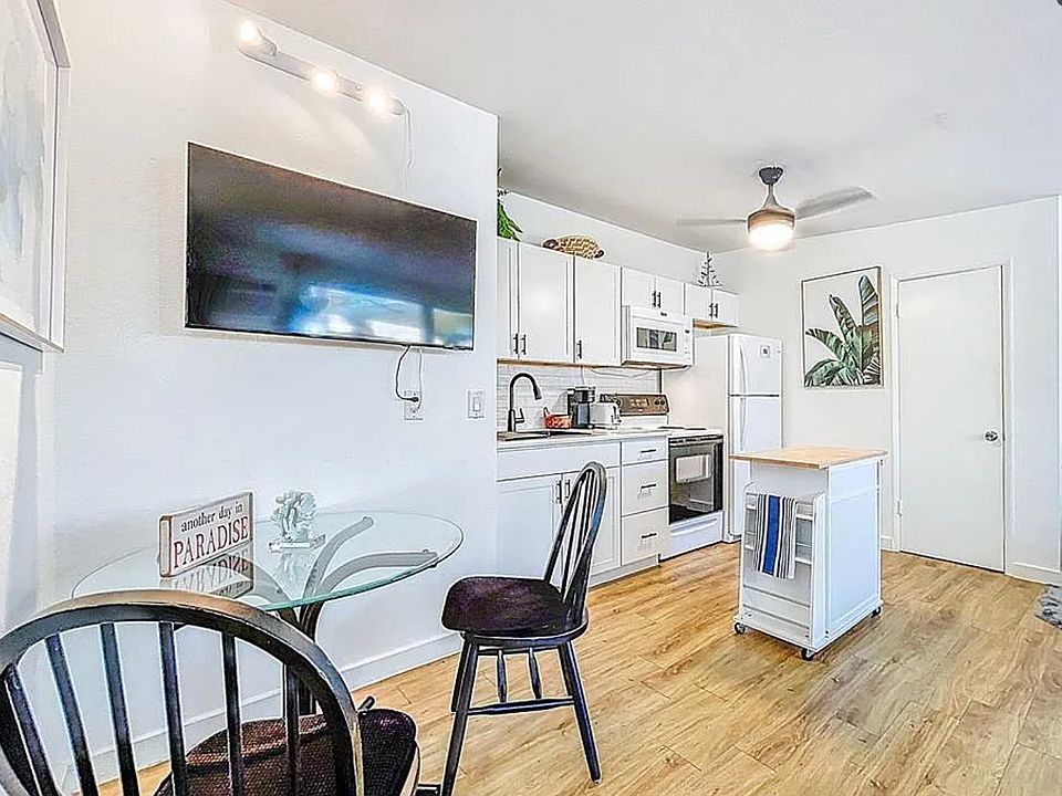 Coastal. Modern Dining space with TV mounted on moveable arm for ease.