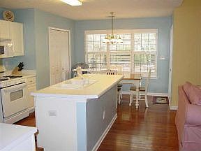 Kitchen island with view of lush backyard