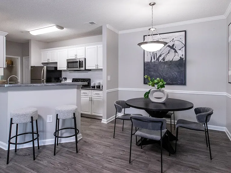 Savor formal meals in a cozy separate dining area adjacent to the modern kitchen or cozy up at the breakfast bar for quick-bit dining delights.