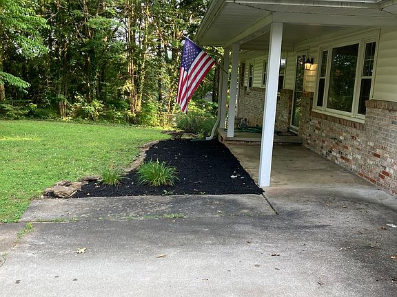 Looking at front porch and flower bed area