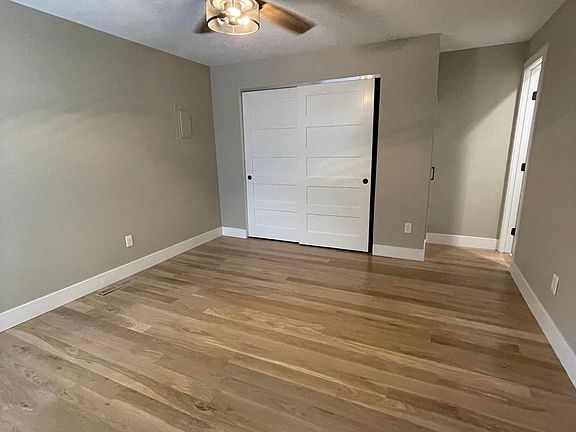 Master Bedroom with white oak floors, spacious closet and ceiling fan.