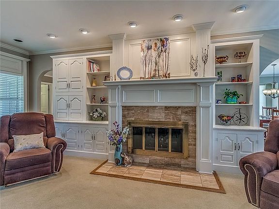 Lovely fireplace with built-in cabinets and shelves.