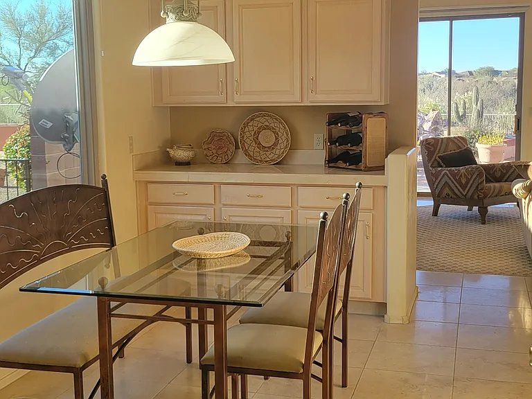 Beautiful breakfast area with morning light. Yes, those cabinets are full - just bring your favorite coffee mug.