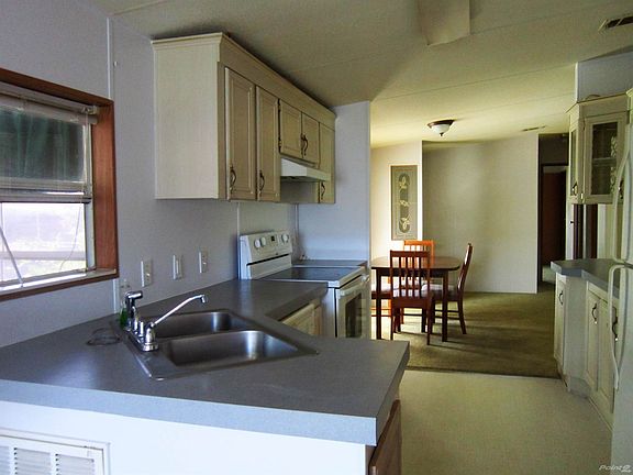 eat in kitchen with  glass front wrap around cupboards for storage