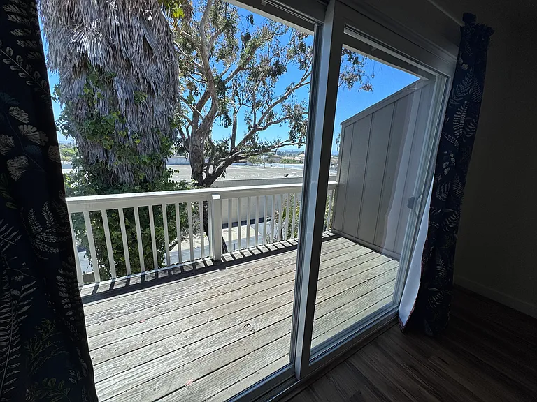 Balcony also has peek of the ocean.