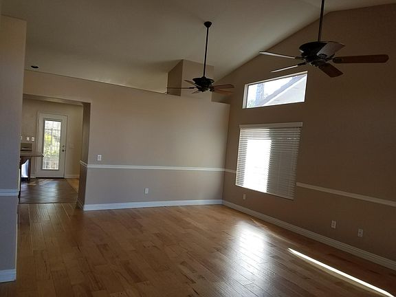 Living /Dining Room with double ceil fans and new hardwood f