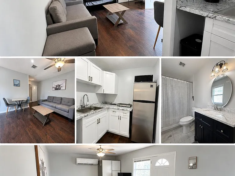 Studio-style space with living area, dining nook, and kitchenette featuring white cabinetry, stone-look counters, and a full