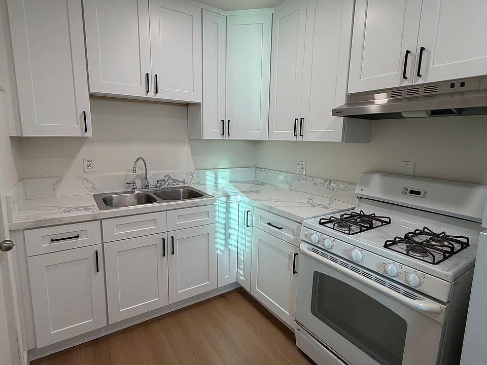 Kitchen with a lot of storage, range and stone countertops