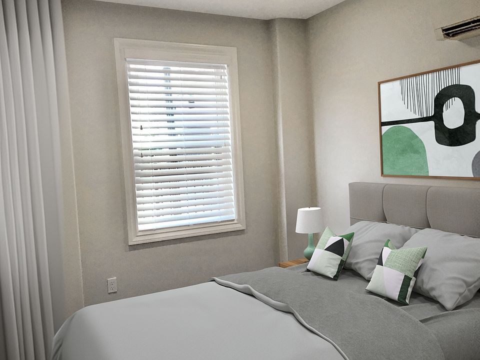 Spacious bedroom with ceiling fan.