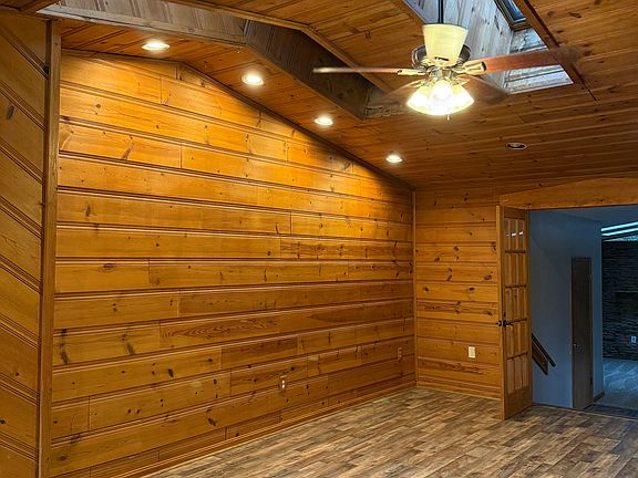 Living Room leading to Carpeted Den or Master Bedroom wiht half bath