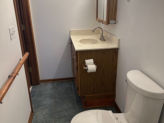 Bathroom at rear of utility room. Photo facing entry into bathroom.