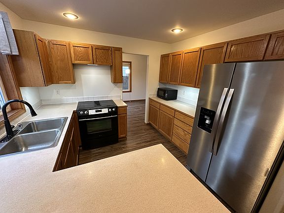 Kitchen with new stainless refrigerator, updated stainless dishwasher and Jenn air range