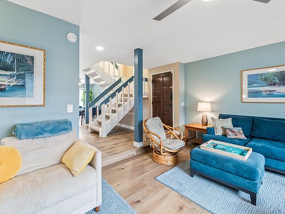 A view to the entryway in the background. On the other side is the dining room and kitchen.