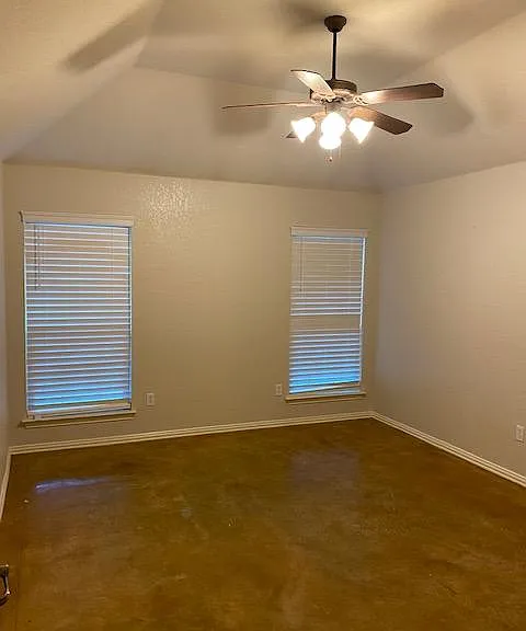 Master Bedroom split with vaulted ceilings, stained concrete floor, new mini blinds