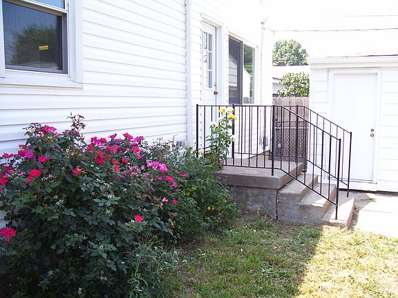 Beautiful rose bushes, mature tree, herbs and perrenials give this a warm feel
