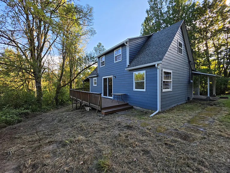 Side of house, showing deck and sliding door into living room