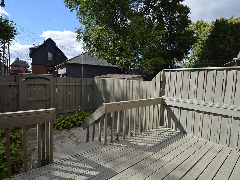 Deck and yard area with access to the one off-street parking spot.