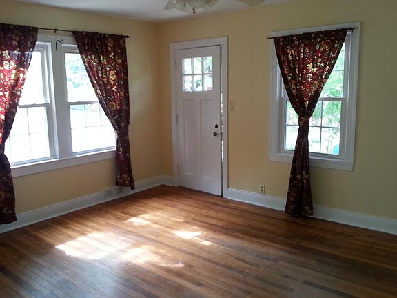 Hardwood floors throughout, including this sunny living room and a side door to the outside.