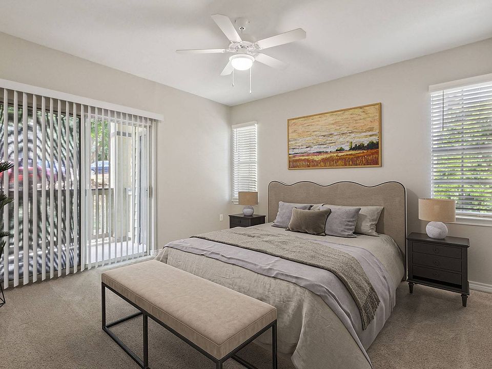 Bedroom with plush carpeting and balcony attached