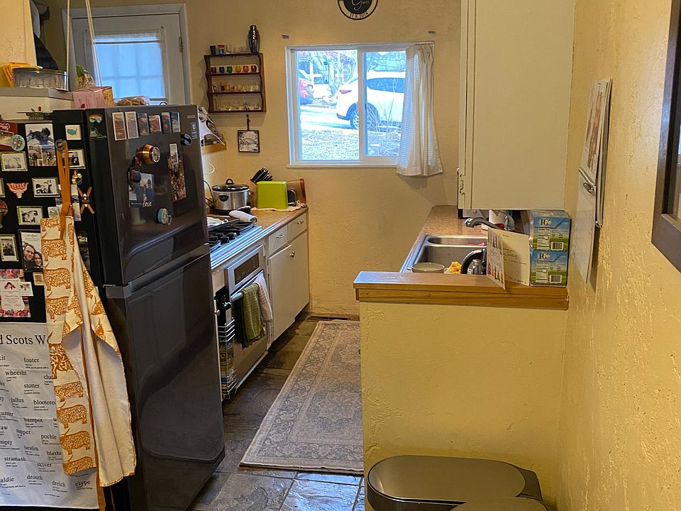 galley kitchen with new appliances and gas stove/oven
