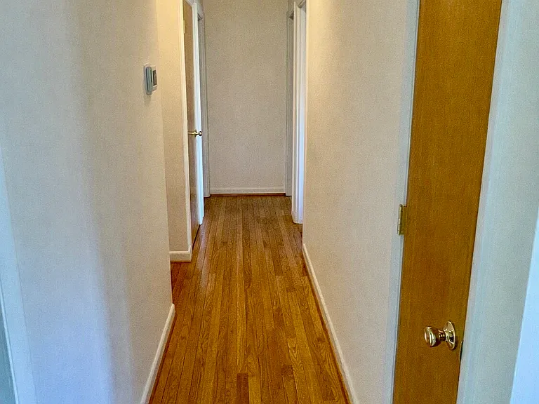 Hallway & pantry. Left hallway to bathroom and 3 other doors to bedrooms.