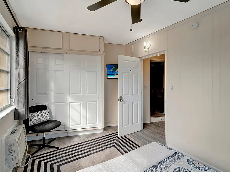 Personal television and large closet with additional storage space above (not pictured - desk underneath tv)