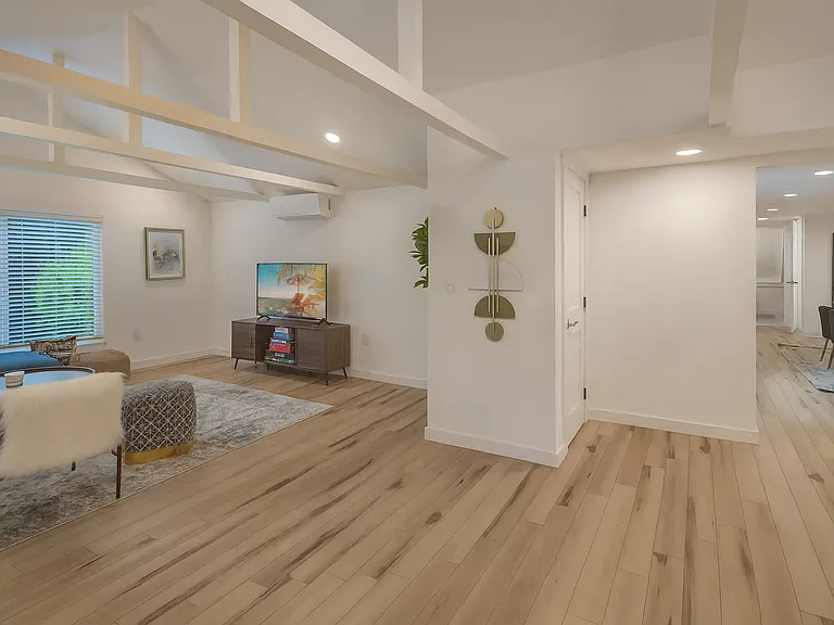 Spacious open floor plan with warm wood flooring, high ceilings, and stylish modern finishes_designed for comfort and flow throughout your stay.