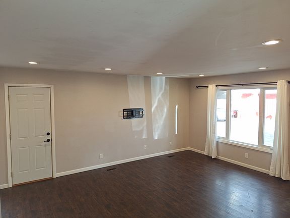 Recessed lighting in living room and kitchen with TV wall mount already installed.