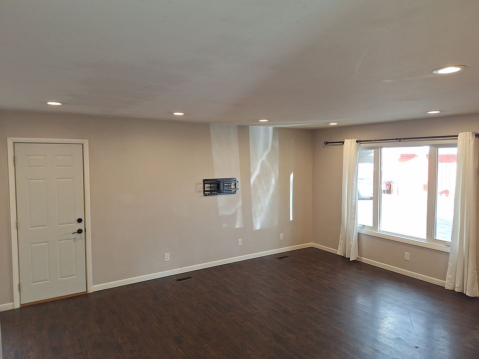 Recessed lighting in living room and kitchen with TV wall mount already installed.