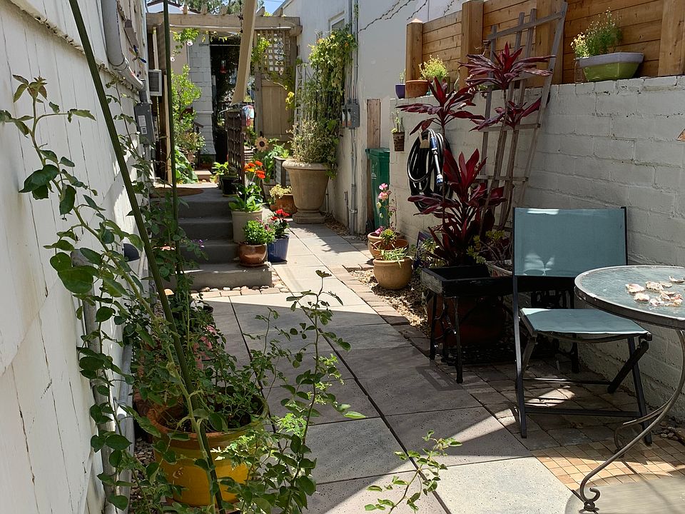 Courtyard pathway from the alley reserved parking to the Cottage front door porch entrance on the left.