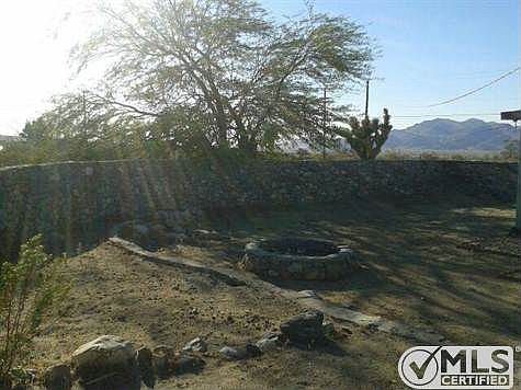 Stone fence surrounding the back and side of the cabin and built-in fire pit.