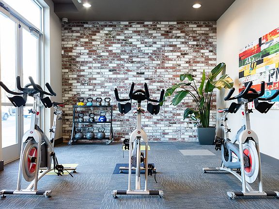 Fitness center with cardio and strength training equipment.