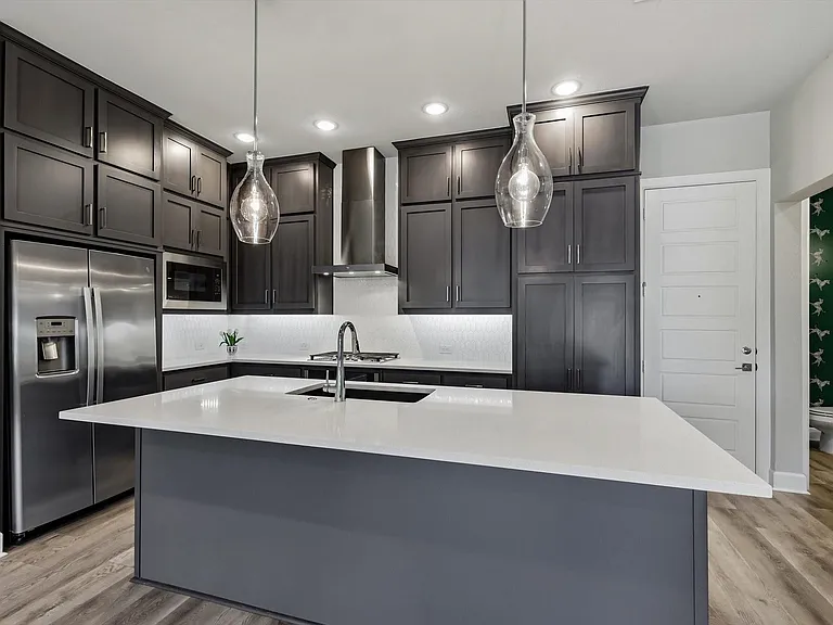 Ample storage, large island, stainless appliances and caesarstone quartz countertops