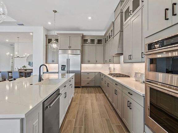 Designer finishes, stainless steel appliances in stylish kitchen