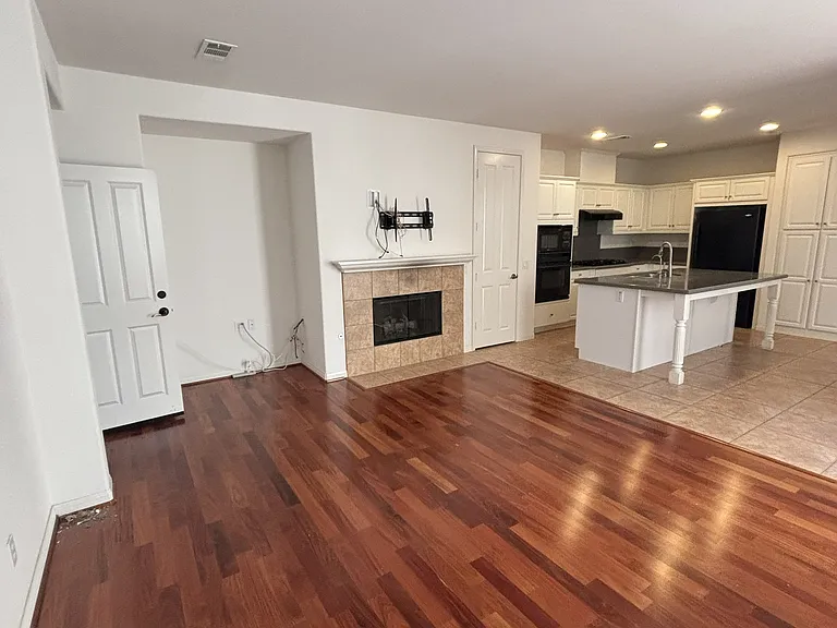 family room, fire place, view of the kitchen