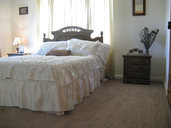 double raised closet with built in drawers below and solid wood sliding doors