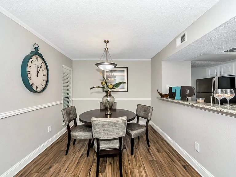 Dedicated dining space with modern lighting and open access to the kitchen.