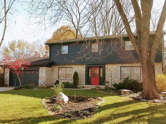 Mature trees and tons of beautiful perennials around this home in well established neighborhood.