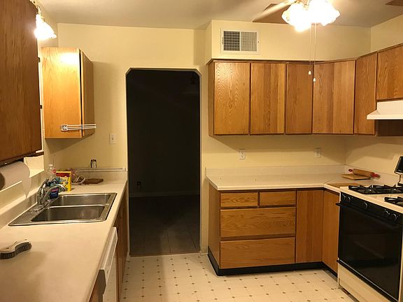Kitchen. Gas stove and grey line sink.