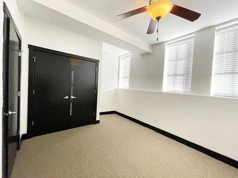 Bedroom with large windows at 3 Points Loft.