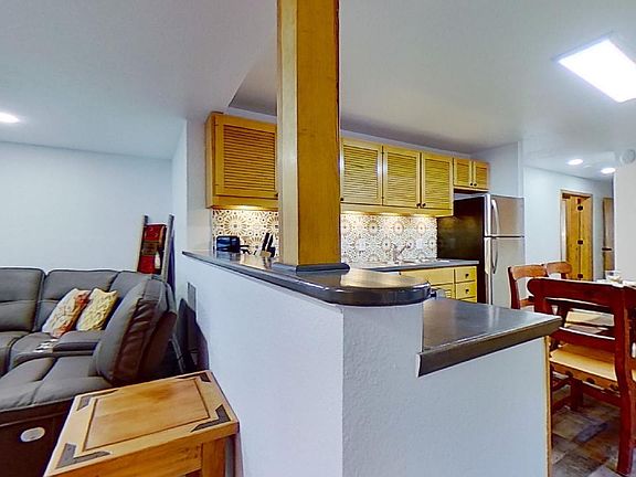 Kitchen looks out over living room