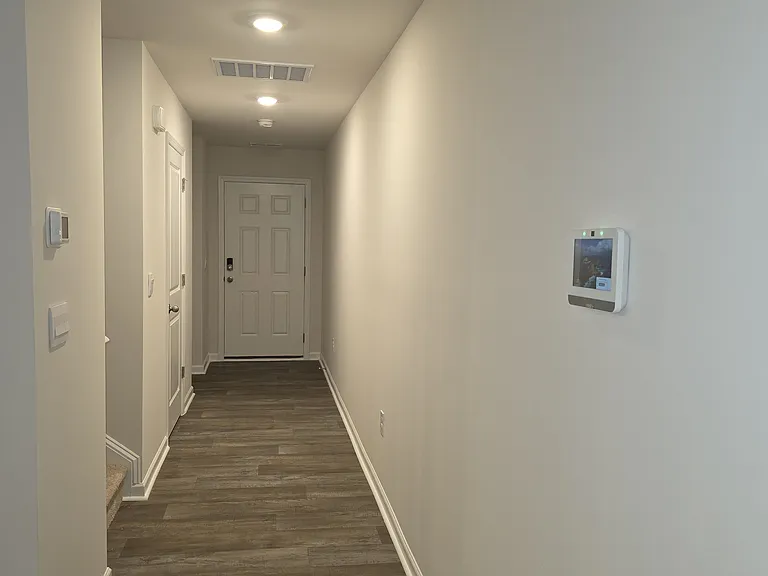 Foyer with half-bath downstairs. Smart home hub and smart thermostats installed.