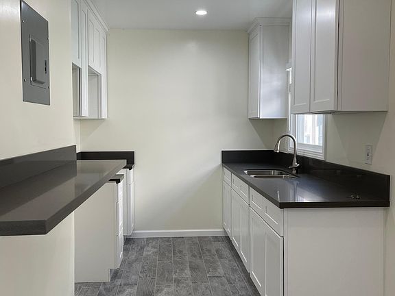 Kitchen wiith recessed light new cabinets and countertops. Eat in kitchen bar