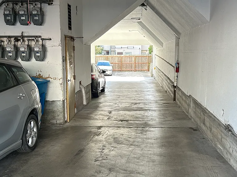 garage entrance. Note separate PGE meters for each unit on wall. Tenant pays for PGE, Water and garbage fee is included with rent.