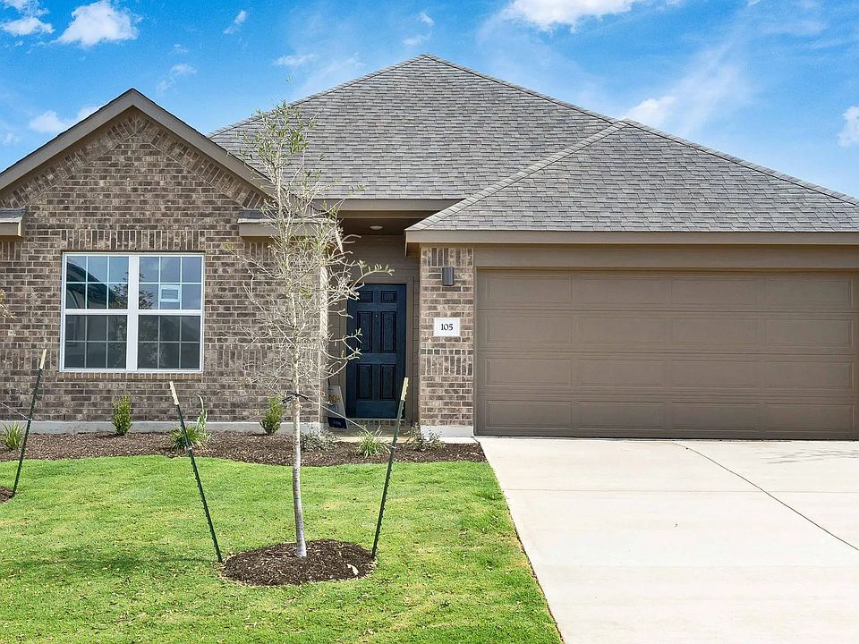 Sophisticated red brick facade and pristine landscape in Blanton at Hunters Glen offer classic subur